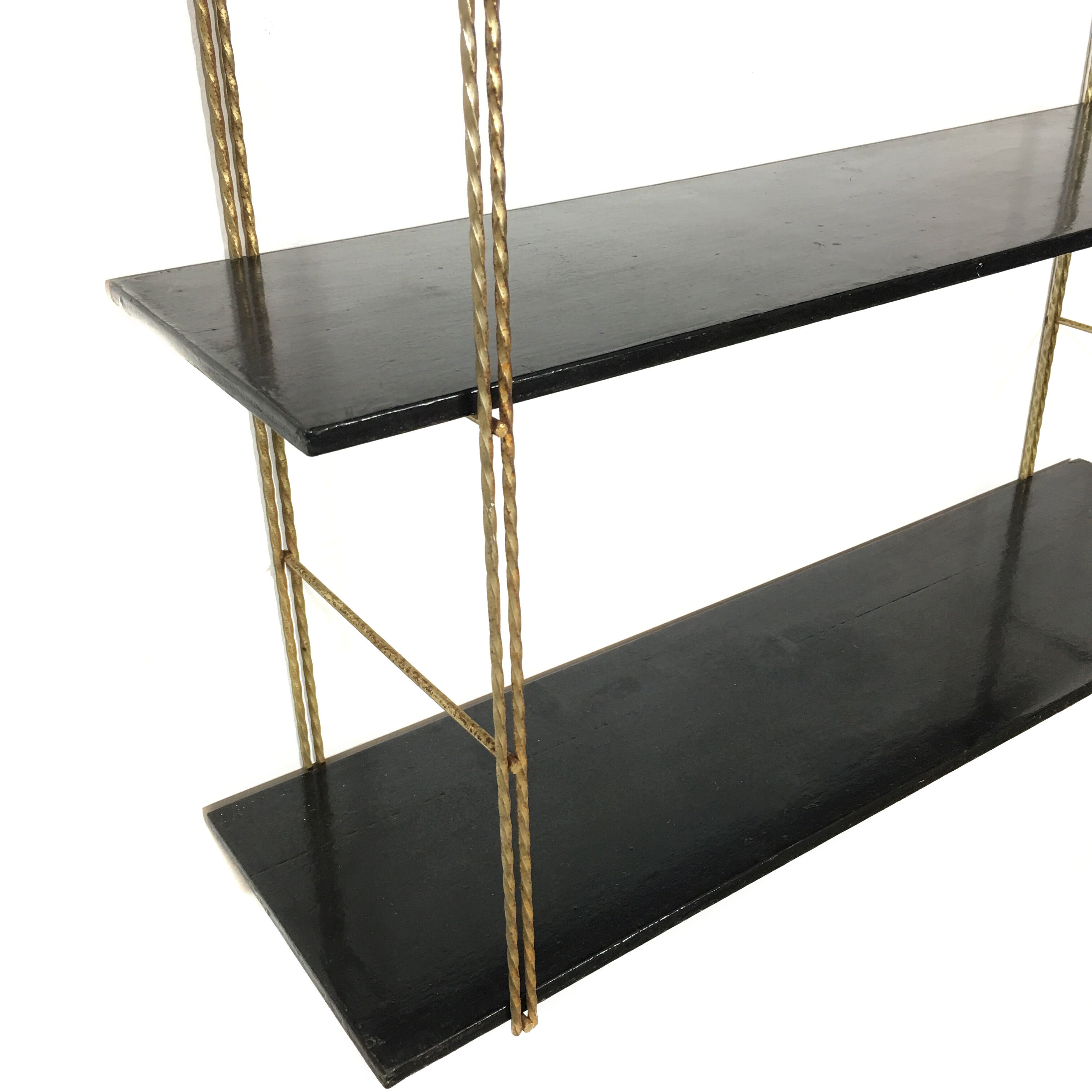 String gold metal shelf and black wood