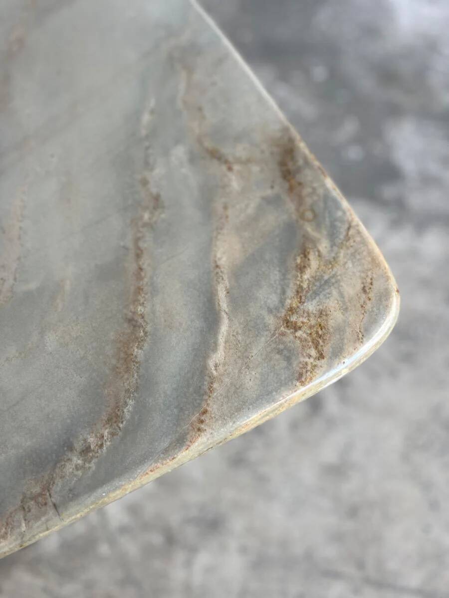 Light gray solid granite coffee table with organic triangular shape and conical base, 1980s