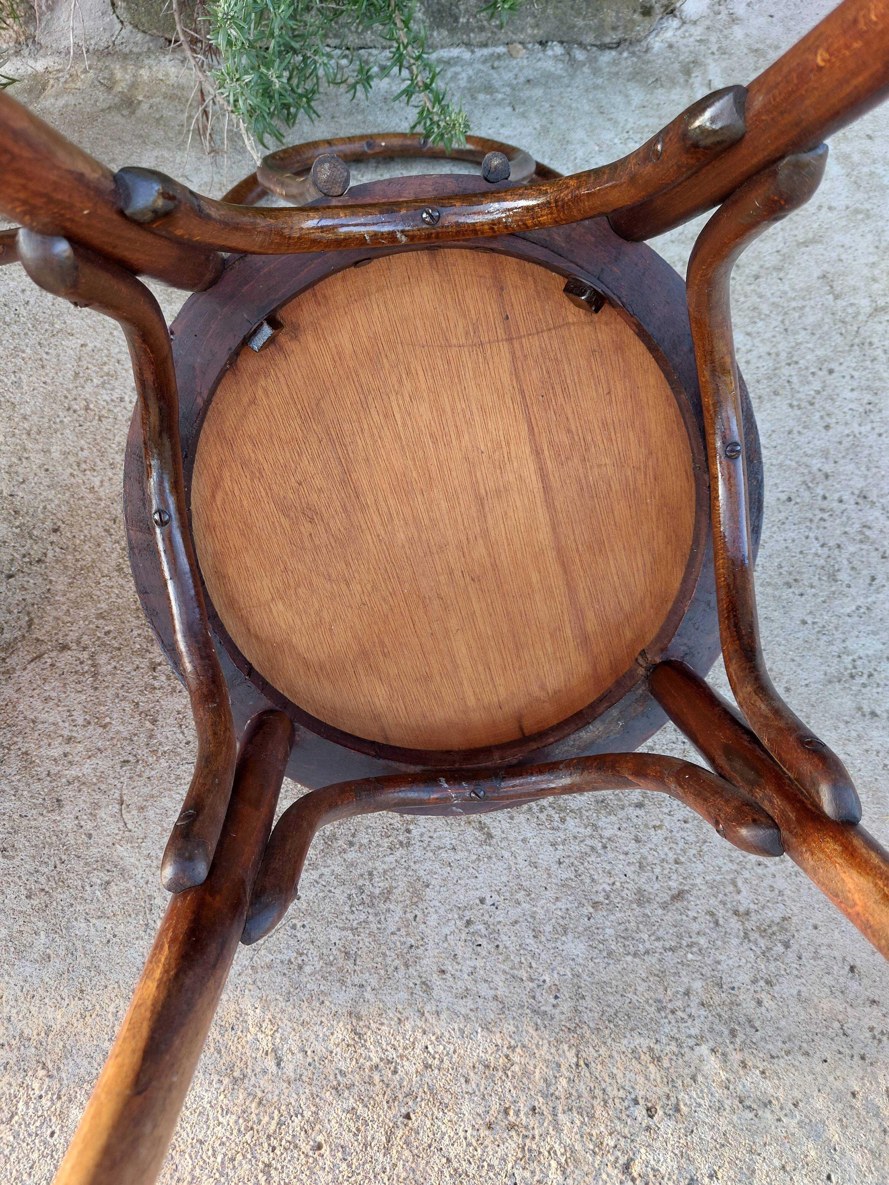 pair of round wooden chairs with a pattern on the seat