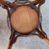 pair of round wooden chairs with a pattern on the seat