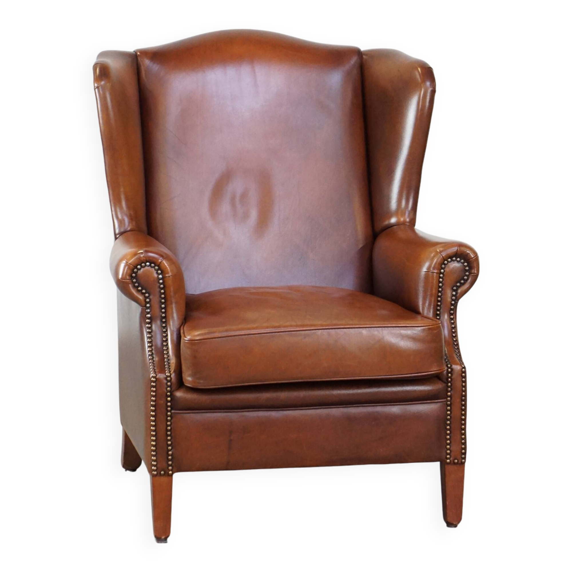 Fauteuil à oreilles en cuir de vachette cognac