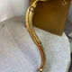 Small corner console in resin with a gold finish.