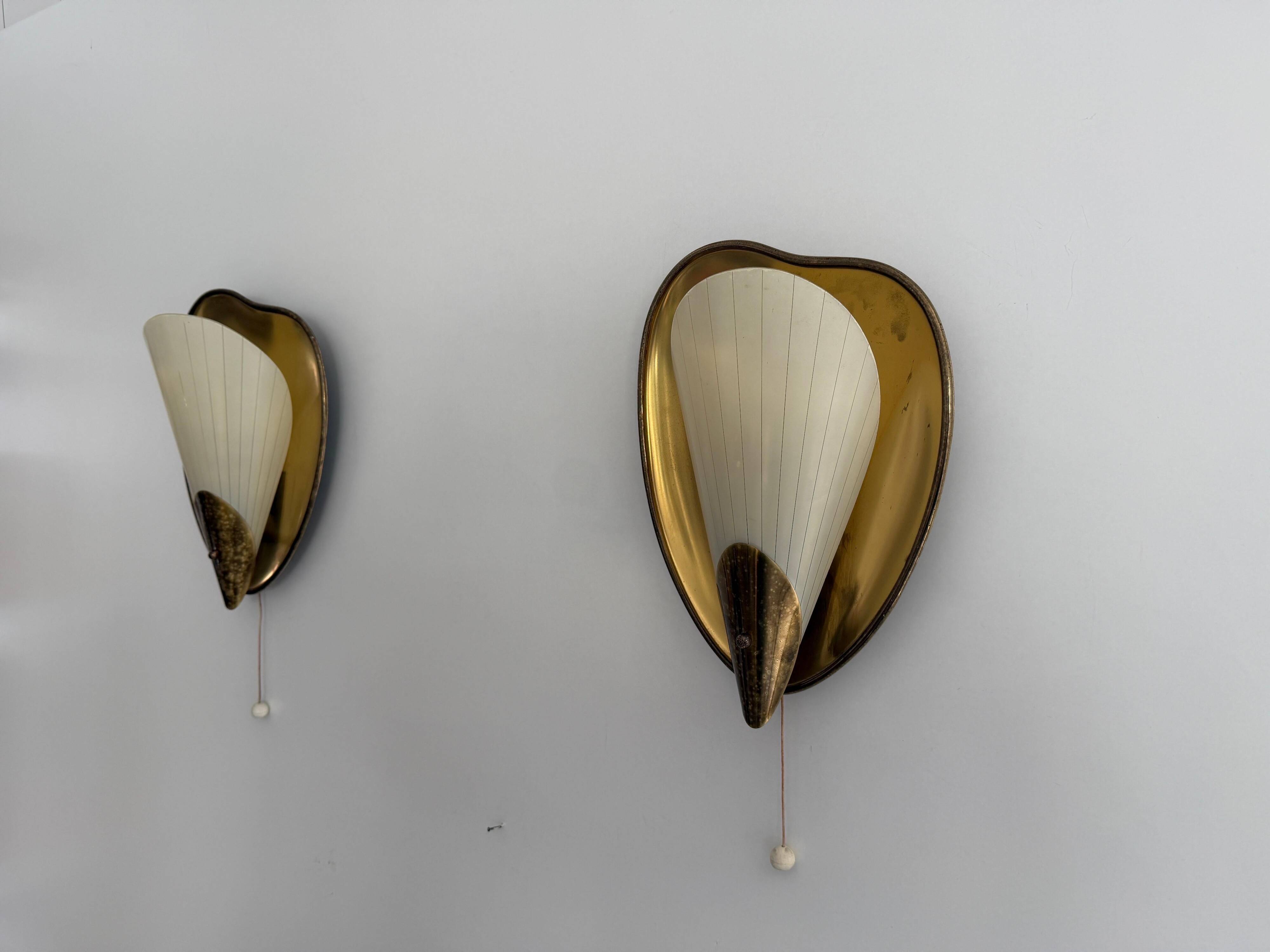 Pair of brass and glass wall lights from the mid-century, 1950s, Germany.