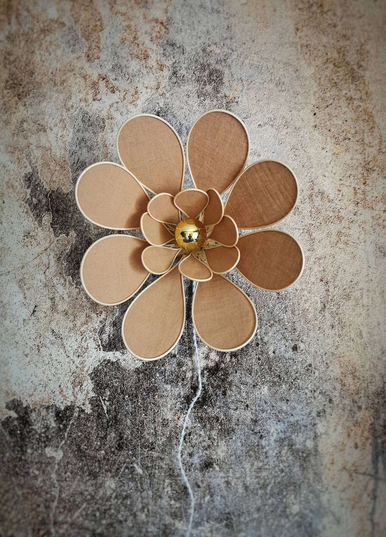 Flower wall light made of rattan and nude linen petals