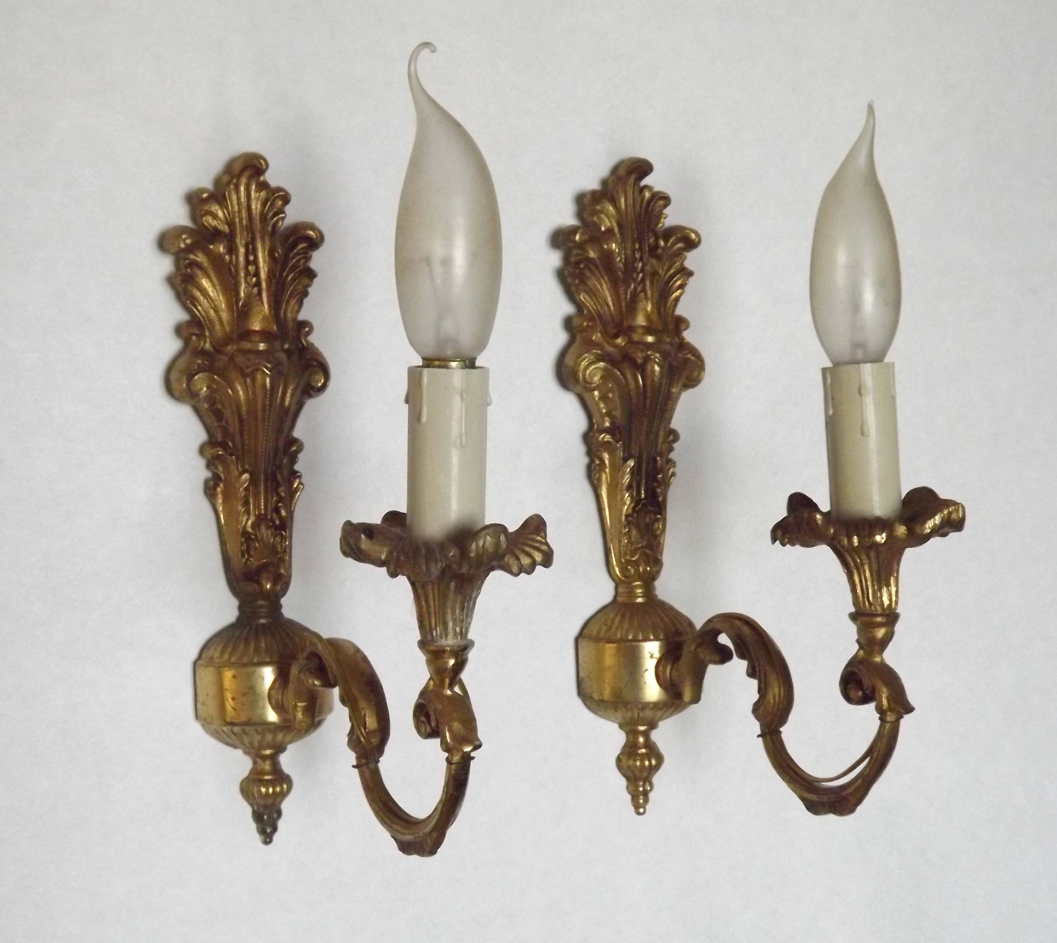 Pair of simple vintage French wall sconces in Art Nouveau bronze with leaf-shaped details.