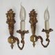 Pair of simple vintage French wall sconces in Art Nouveau bronze with leaf-shaped details.