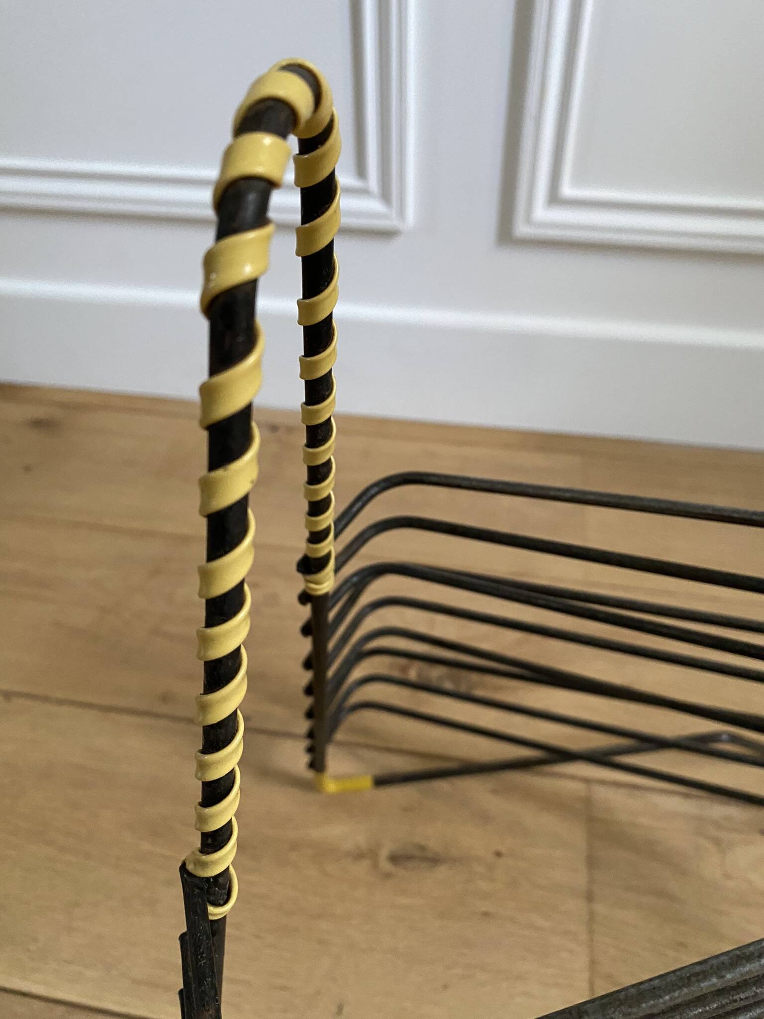 Black metal vinyl record holder and yellow scoubidou from the 60s