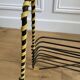Black metal vinyl record holder and yellow scoubidou from the 60s