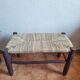 Moroccan bench in dark wood with woven palm leaf seat