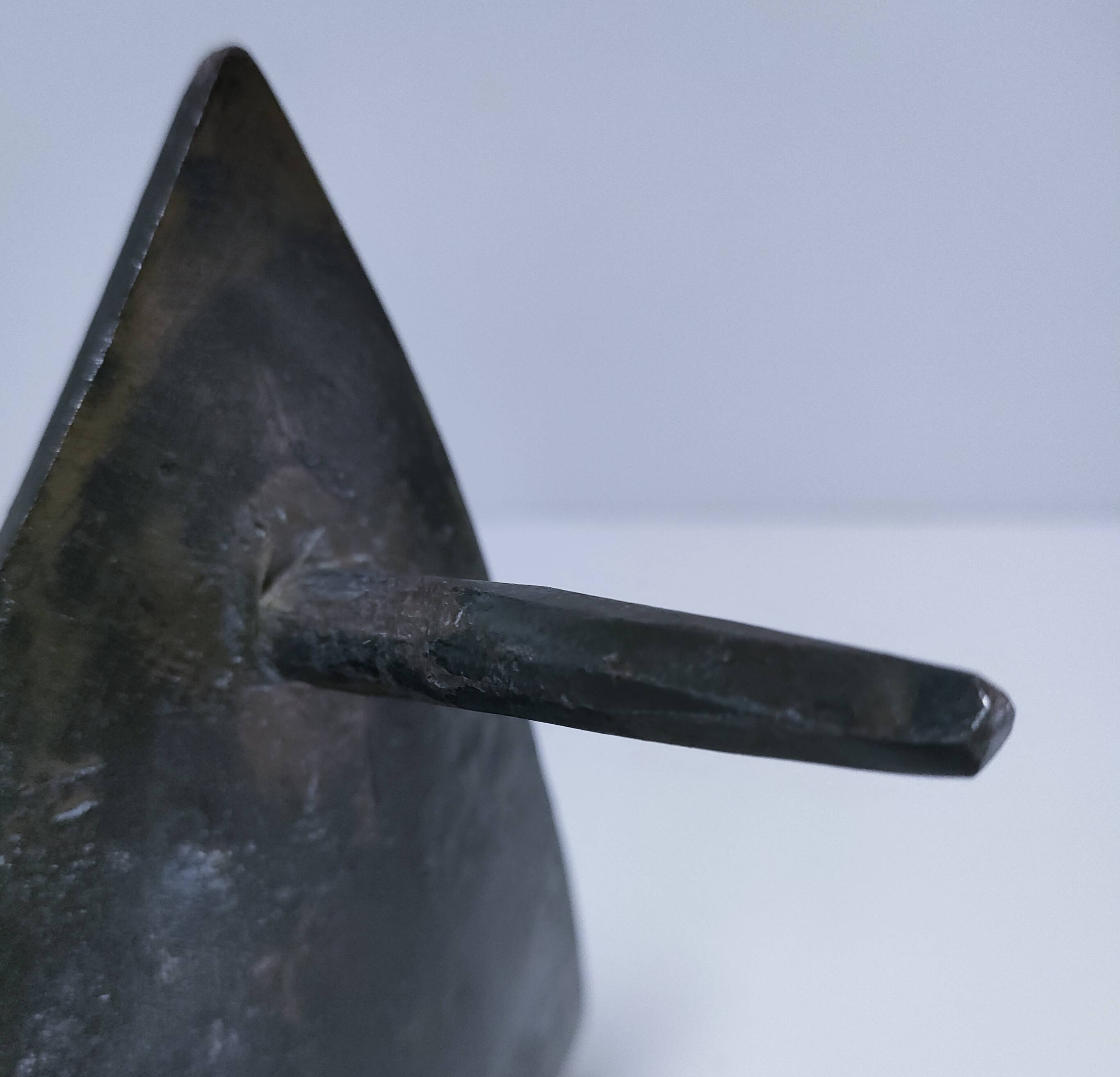 Brutalist metal pocket with patinated tripod