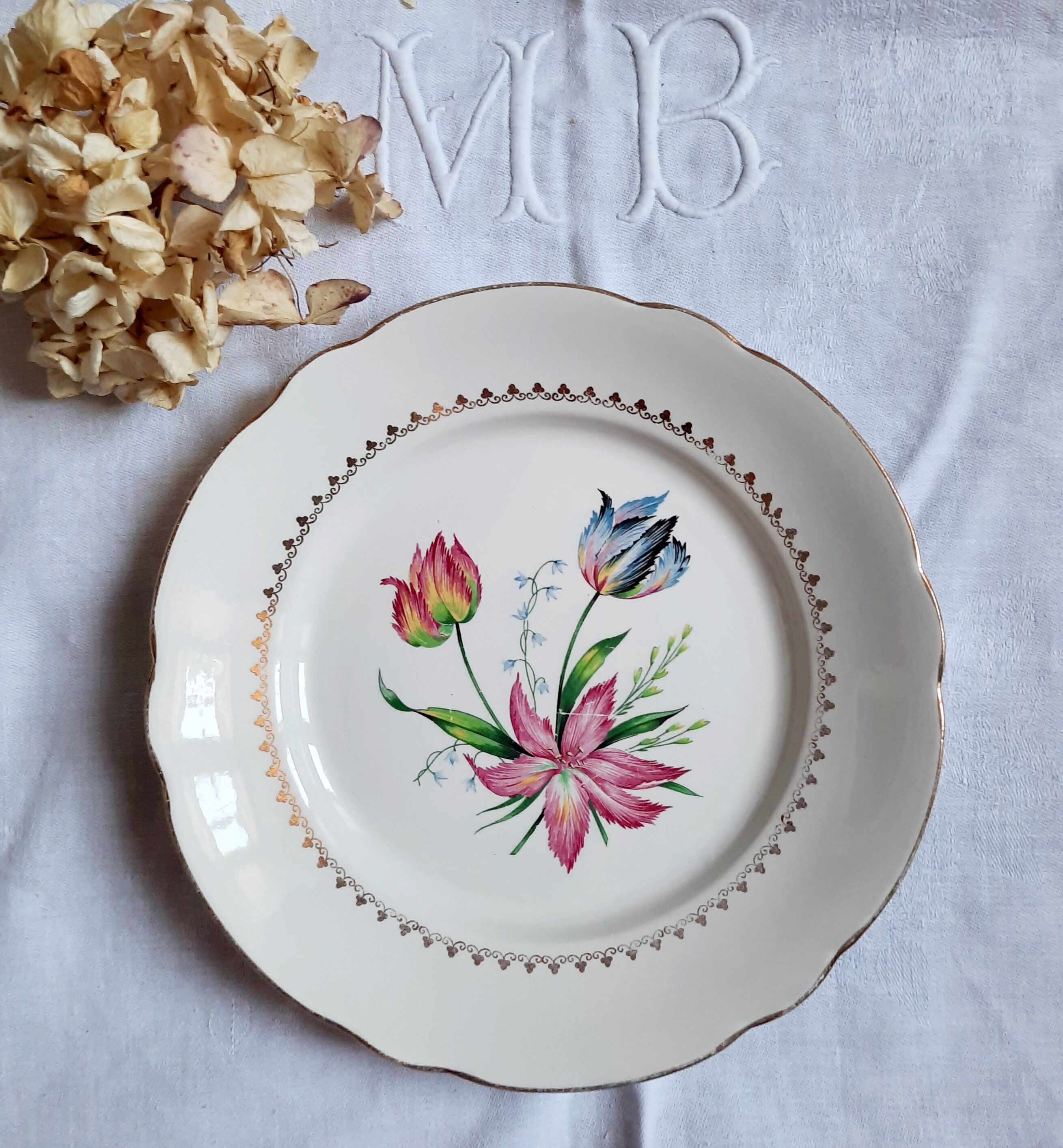 Flat antique earthenware plates with gilded edges