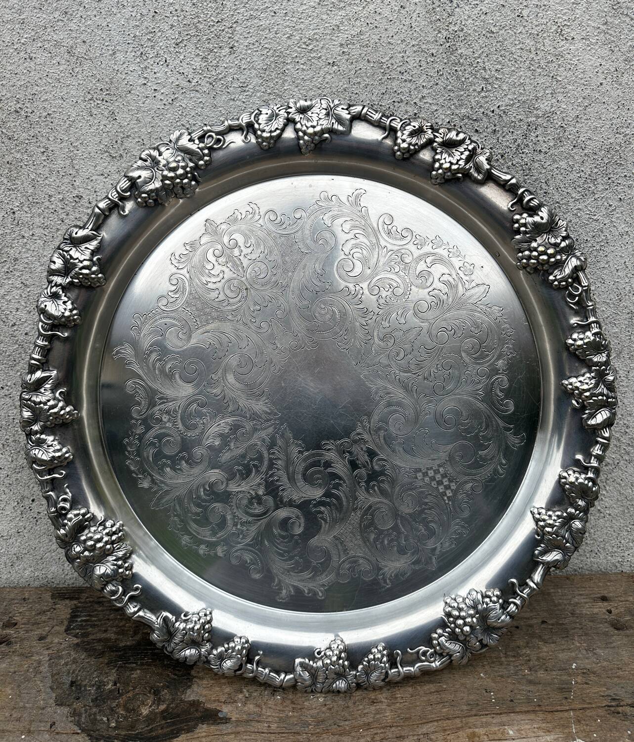 Antique round silver serving platter, grape motifs.