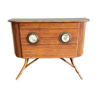 Rattan and wood bar with its decorative brass portholes