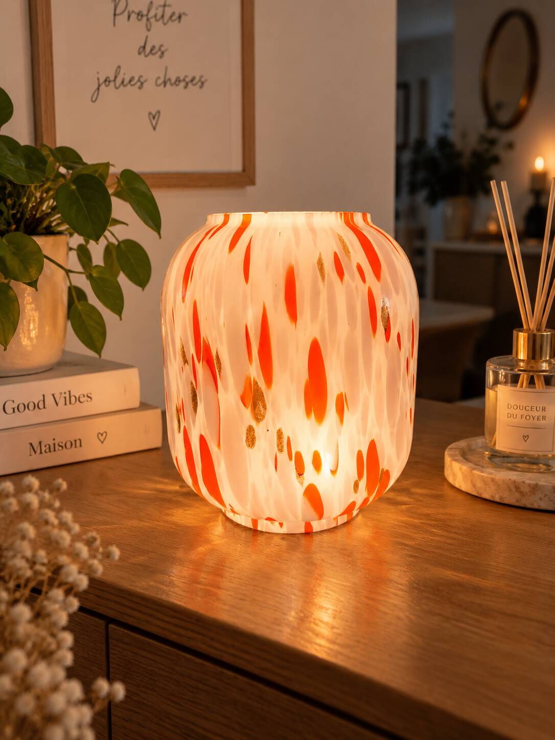 Vintage orange and white glass lamp with golden accents.