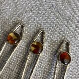 Art Nouveau metal and amber spoons