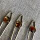 Art Nouveau metal and amber spoons