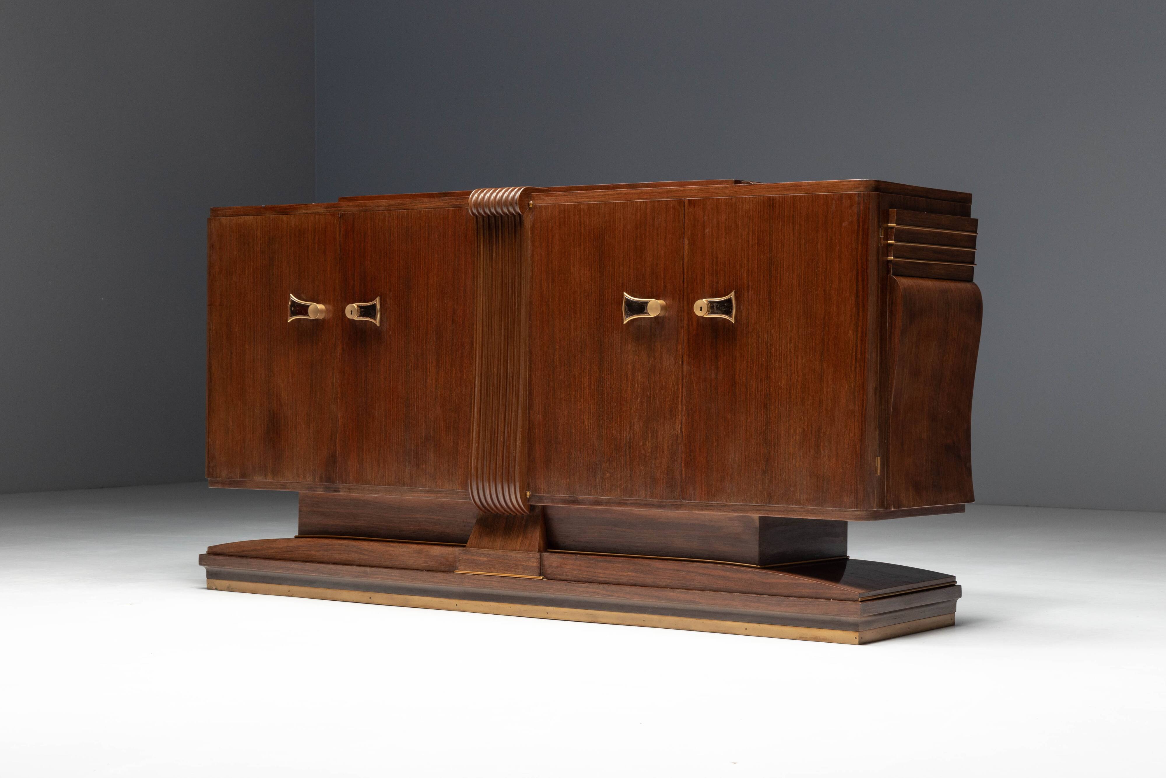 Art Deco walnut sideboard with brass details and sculptural base, France, 1930s