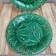 Set of 2 green earthenware dessert plates with vine decoration.