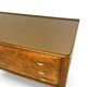 Veneered burl walnut chest of drawers with light warm brown glass top