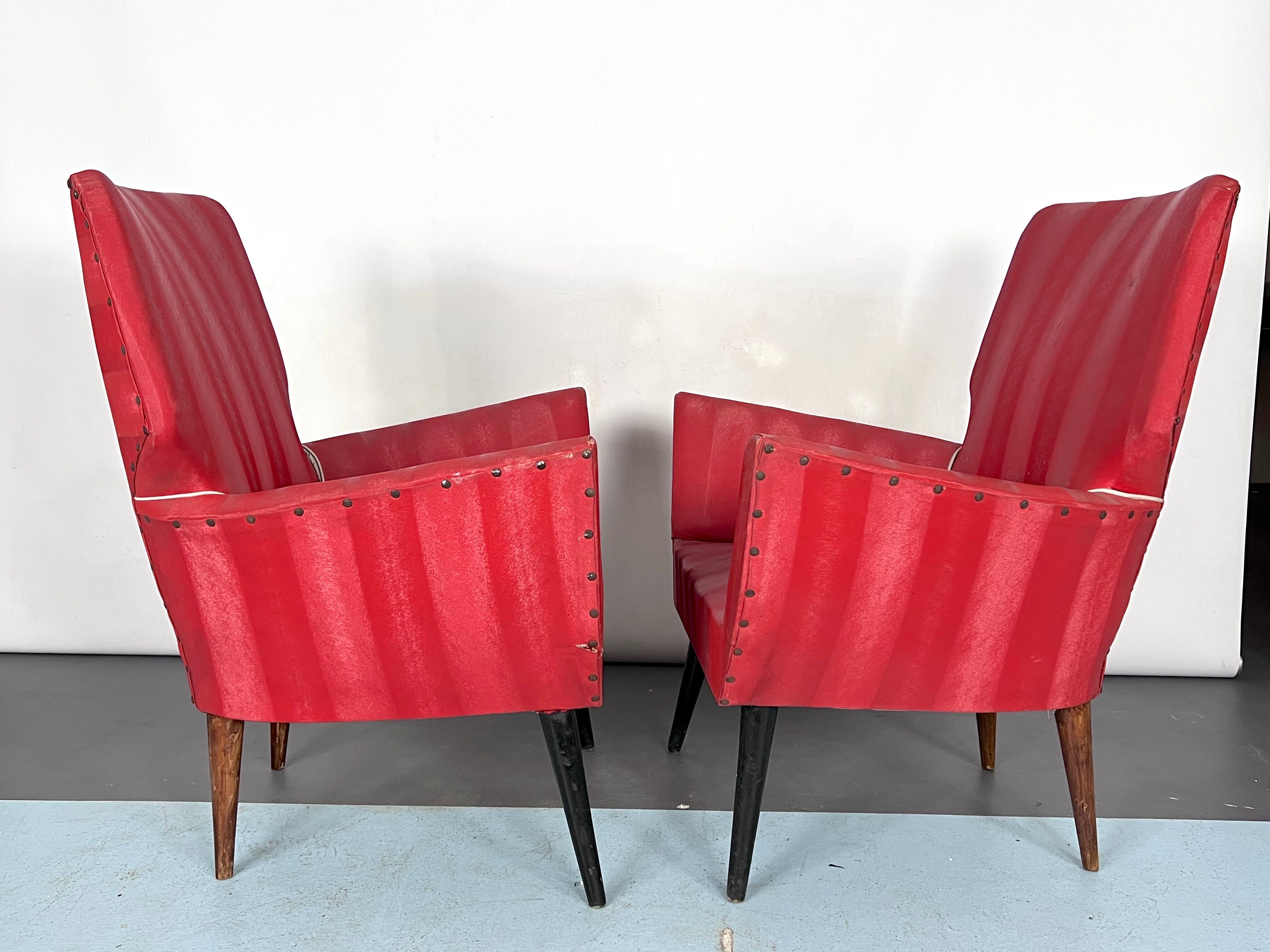 Mid-century modern pair of red armchairs. italy 1950s