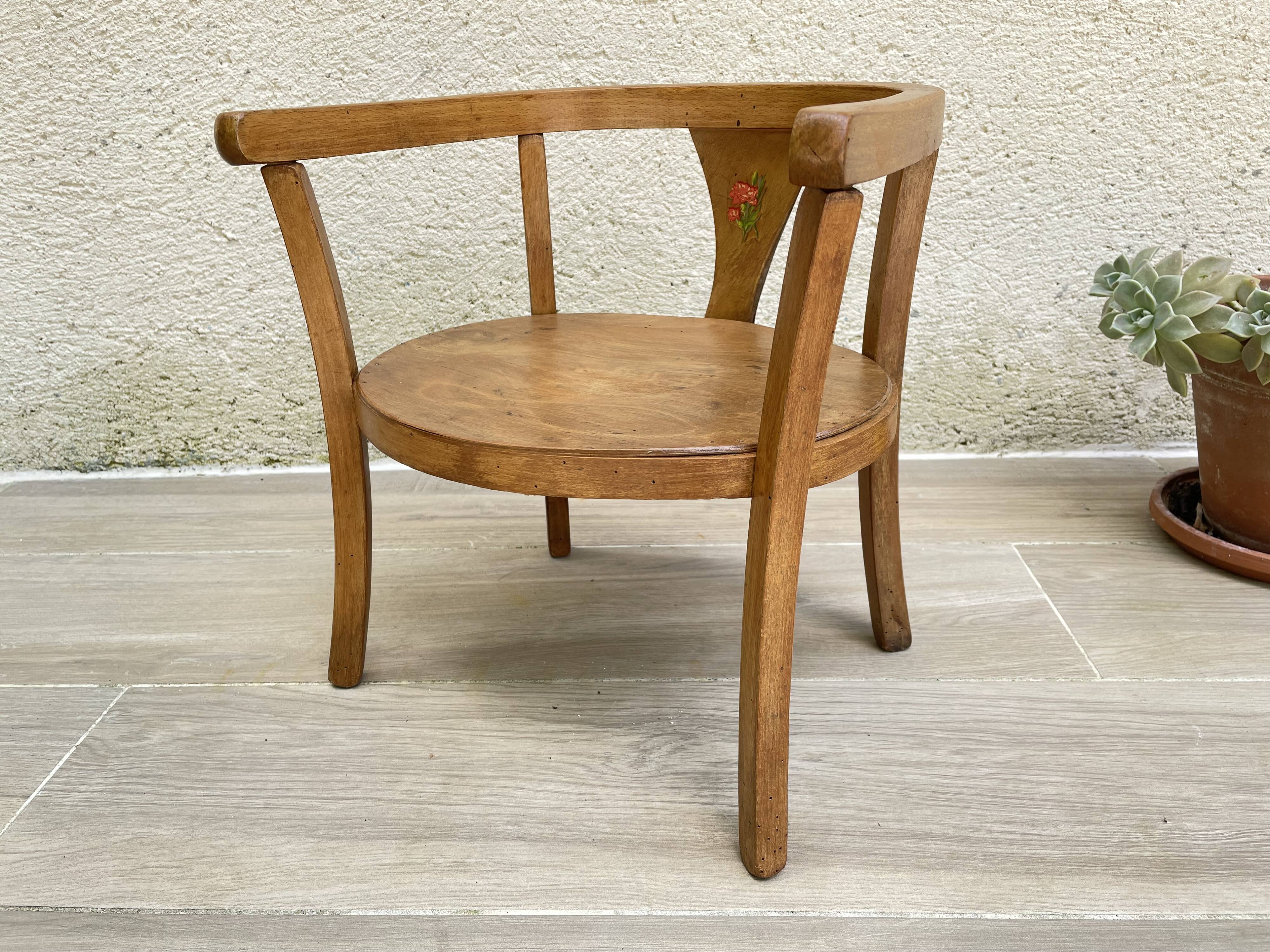 Old armchair for children in wood