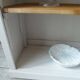 Shallow depth bookcase re-enchanted in pearl gray, wooden shelves.