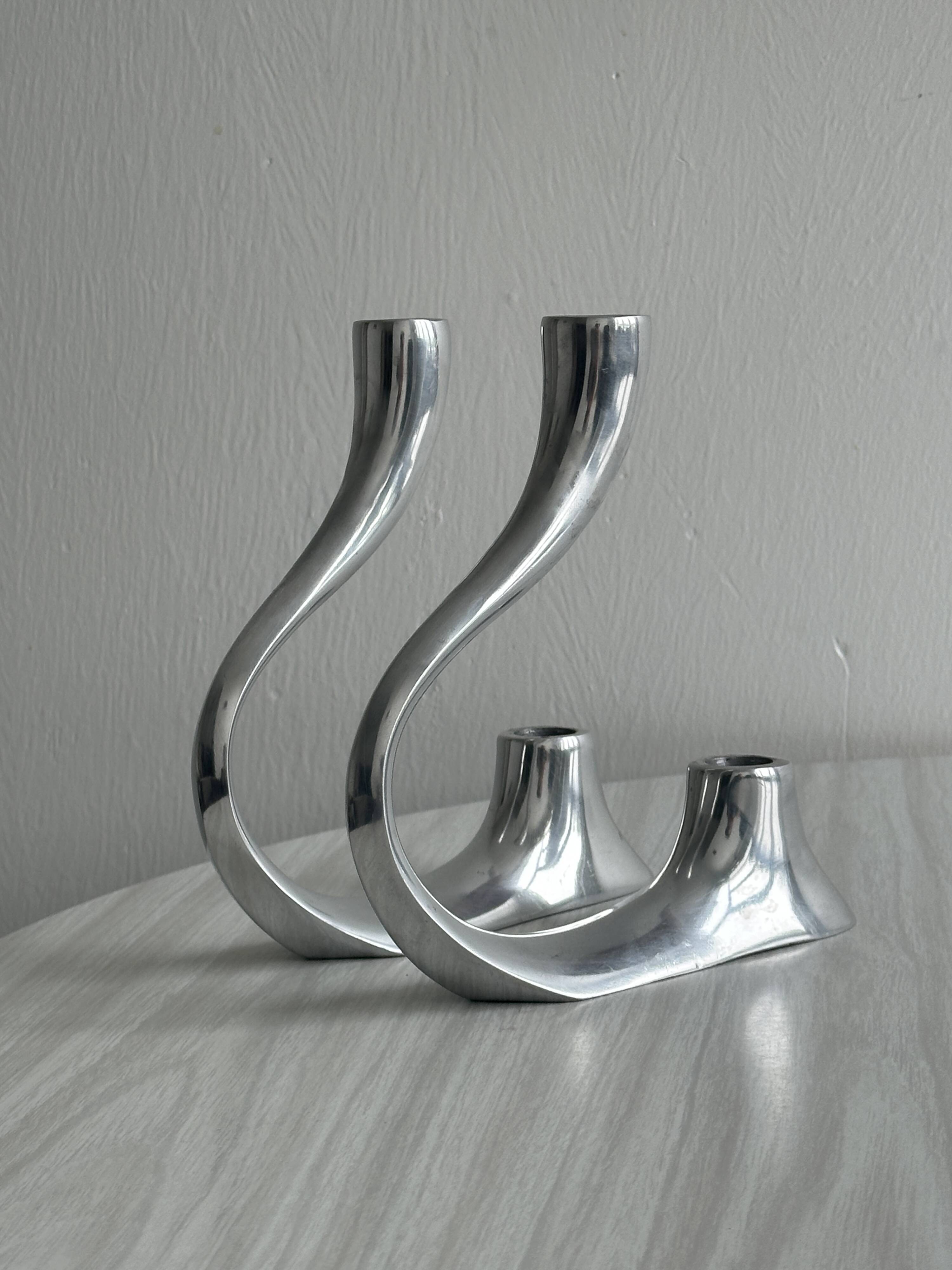 Pair of designer candlesticks in chromed metal
