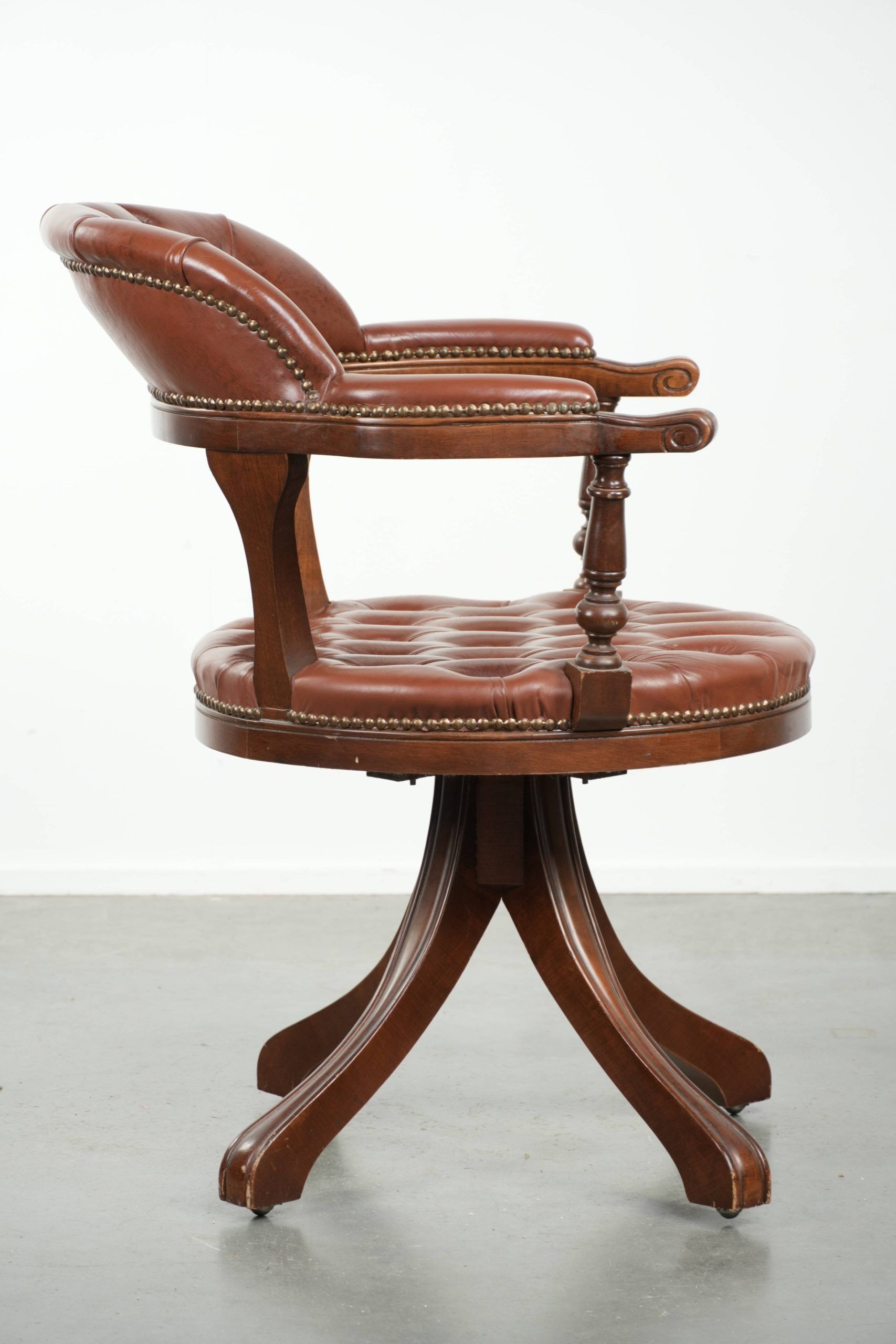Swivel cowhide English style chesterfield office chair in a brown colour