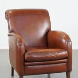 Cognac-colored sheepskin armchair with rounded shapes