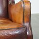 Vintage sheepskin leather armchair finished with black piping