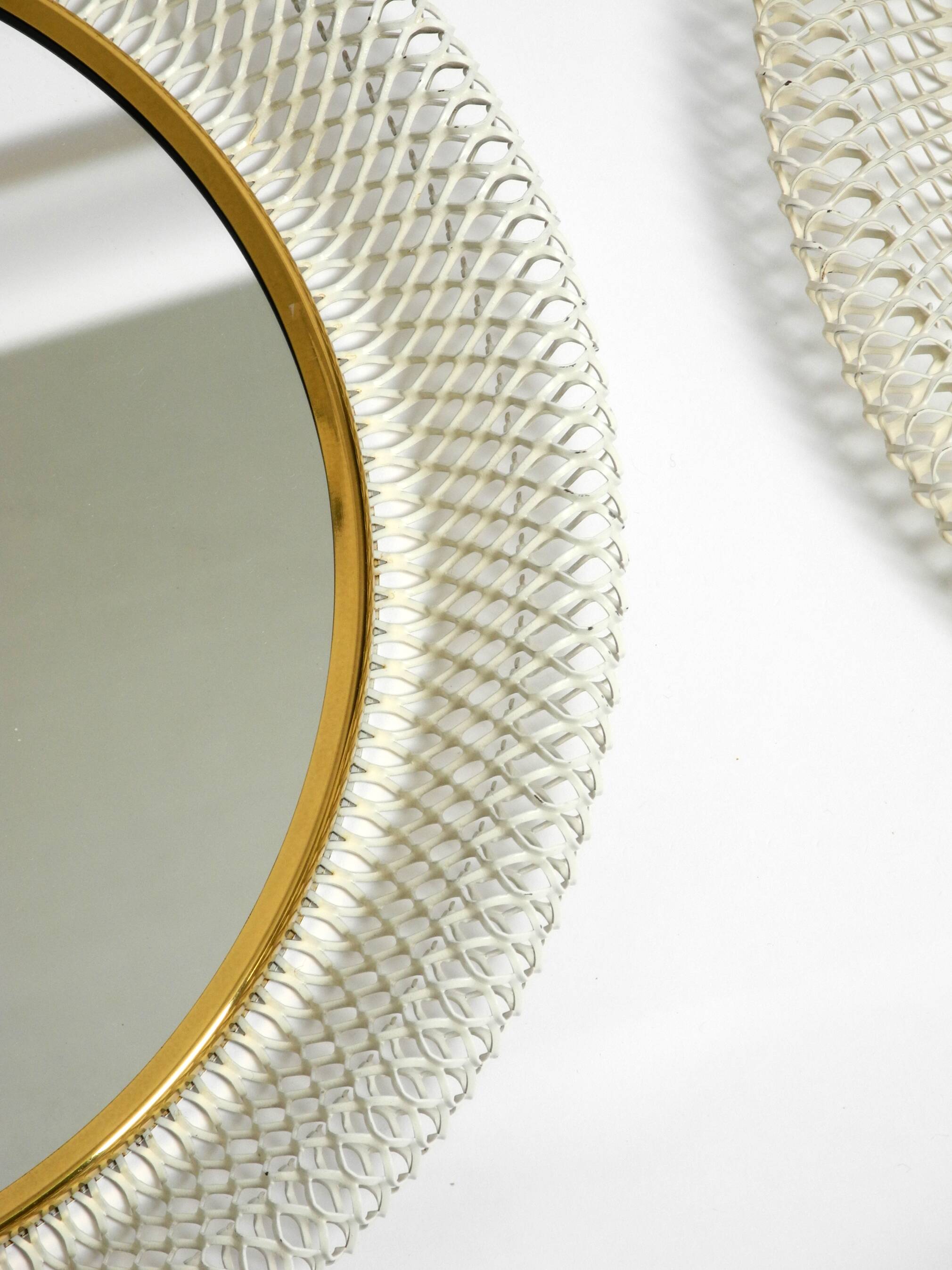 Pair of Mid Century wall mirrors with brass rim and white metal frames