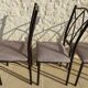4 black metal chairs with high backs and gray suede tops
