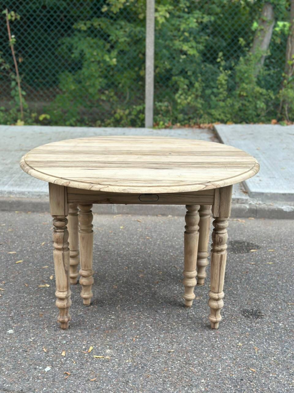 Round extendable dining table with flaps, stripped in raw oak, with 4 extensions.