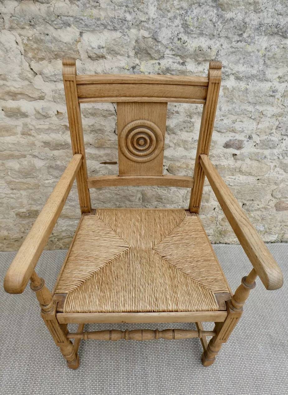 Light wood neo-Basque armchair with caned seat.