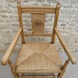 Light wood neo-Basque armchair with caned seat.