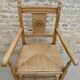 Fauteuil néo basque en bois clair et assise cannée
