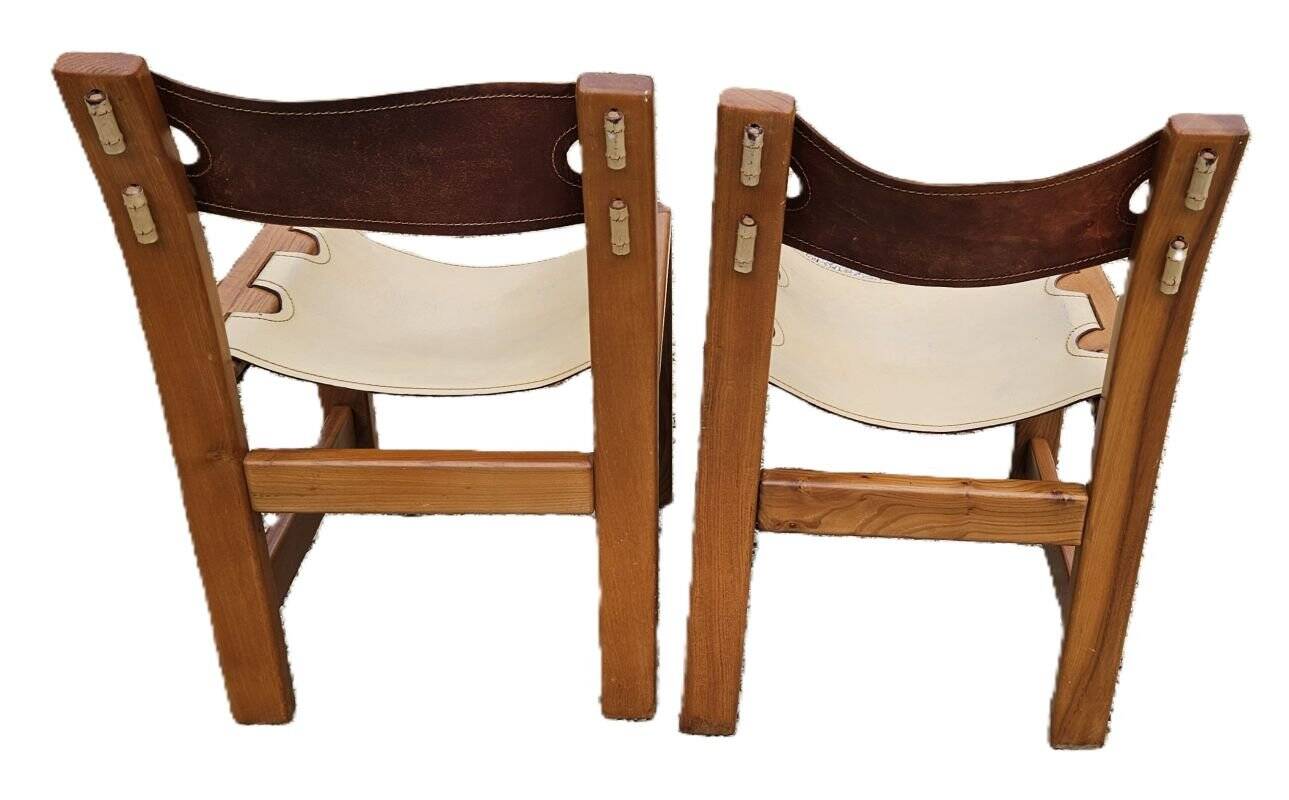 Pair of elm and leather chairs by Maison Regain