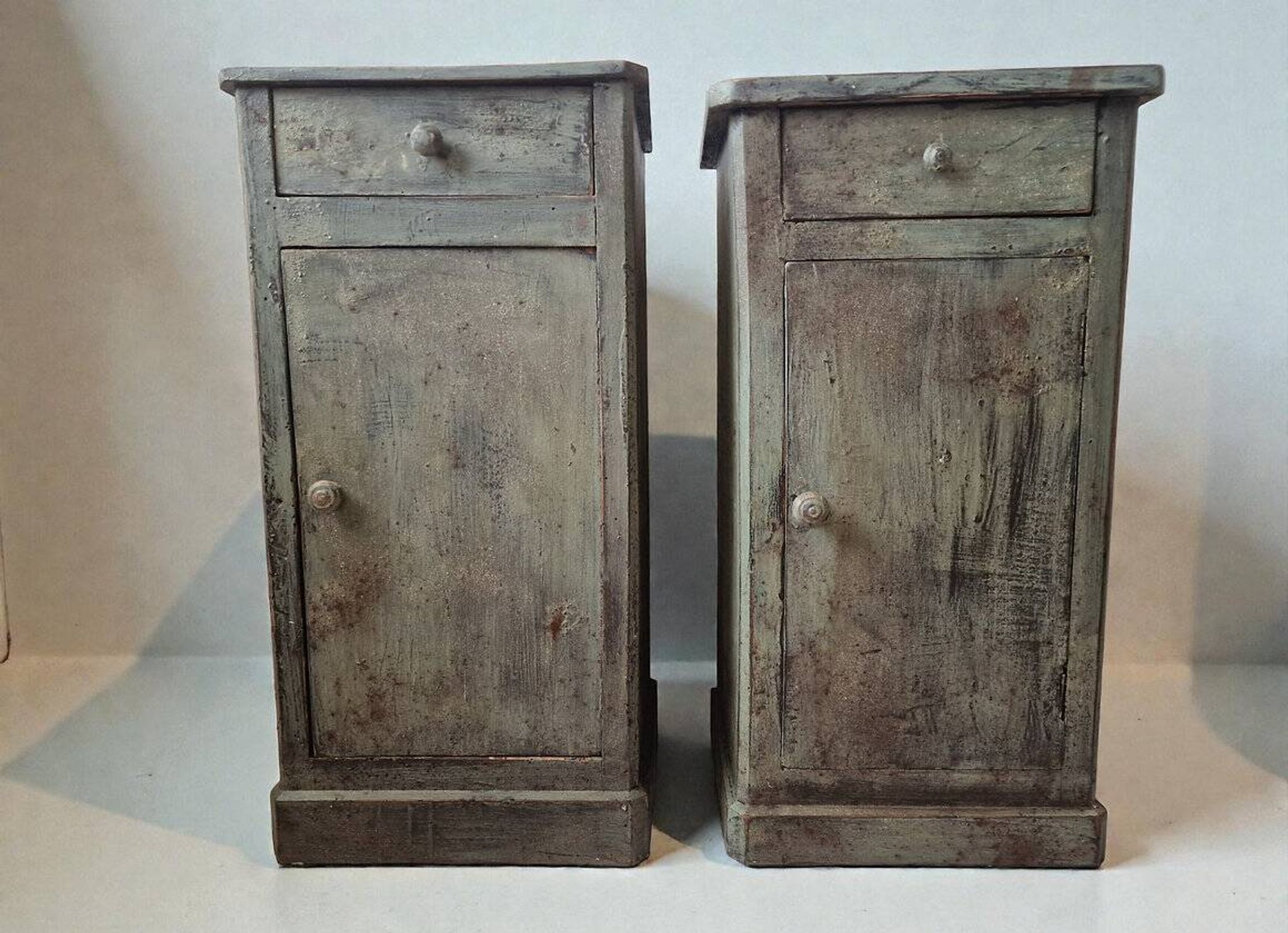 Pair of antique bedside tables with a green patina