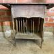 Antique writing desk, blackened wooden filing cabinet.