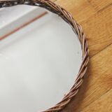 Decorative mirror tray surrounded by vintage rattan / wicker