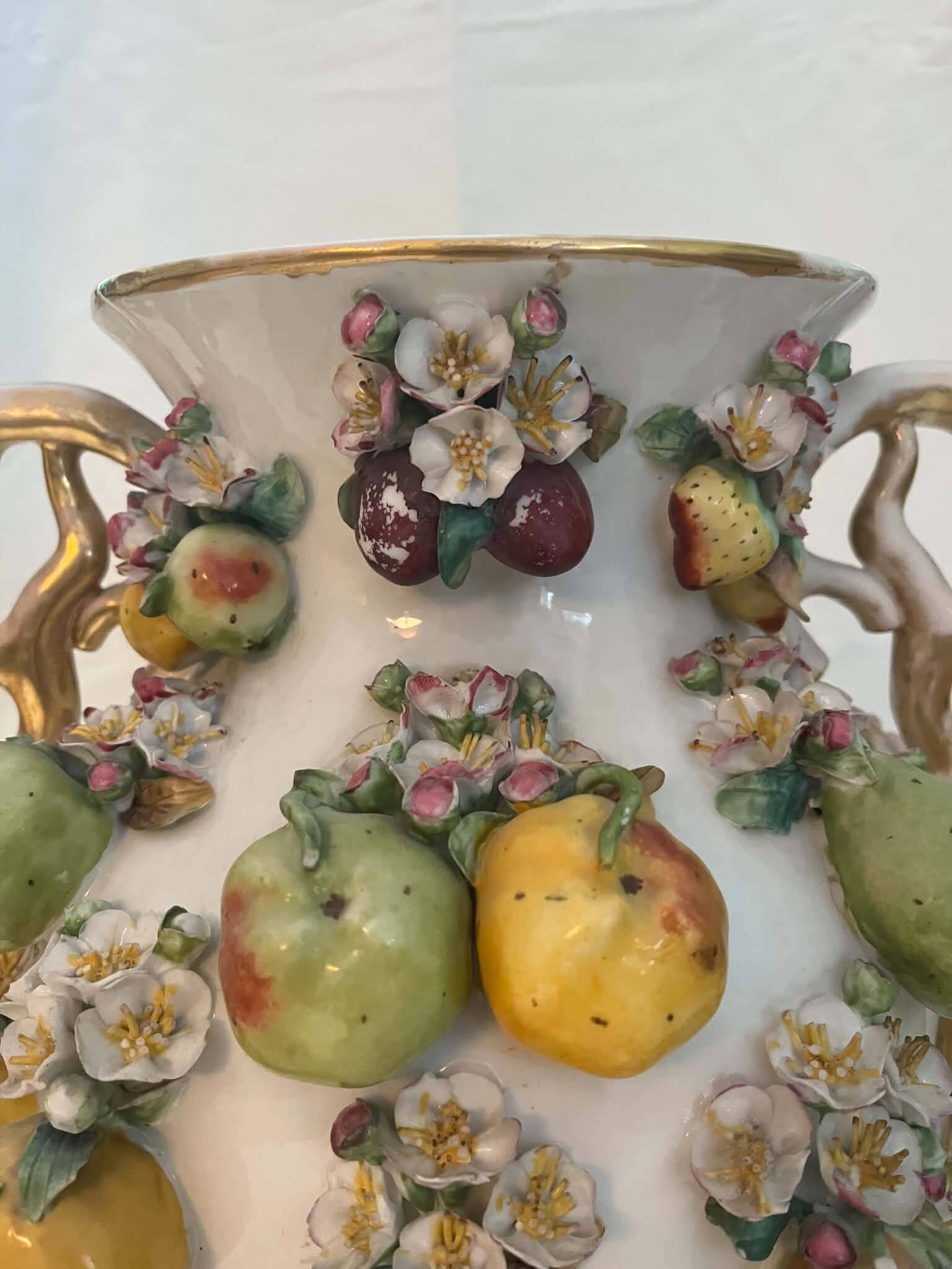 Large antique vase with relief decorations of coloured fruits.