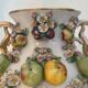 Large antique vase with relief decorations of coloured fruits.