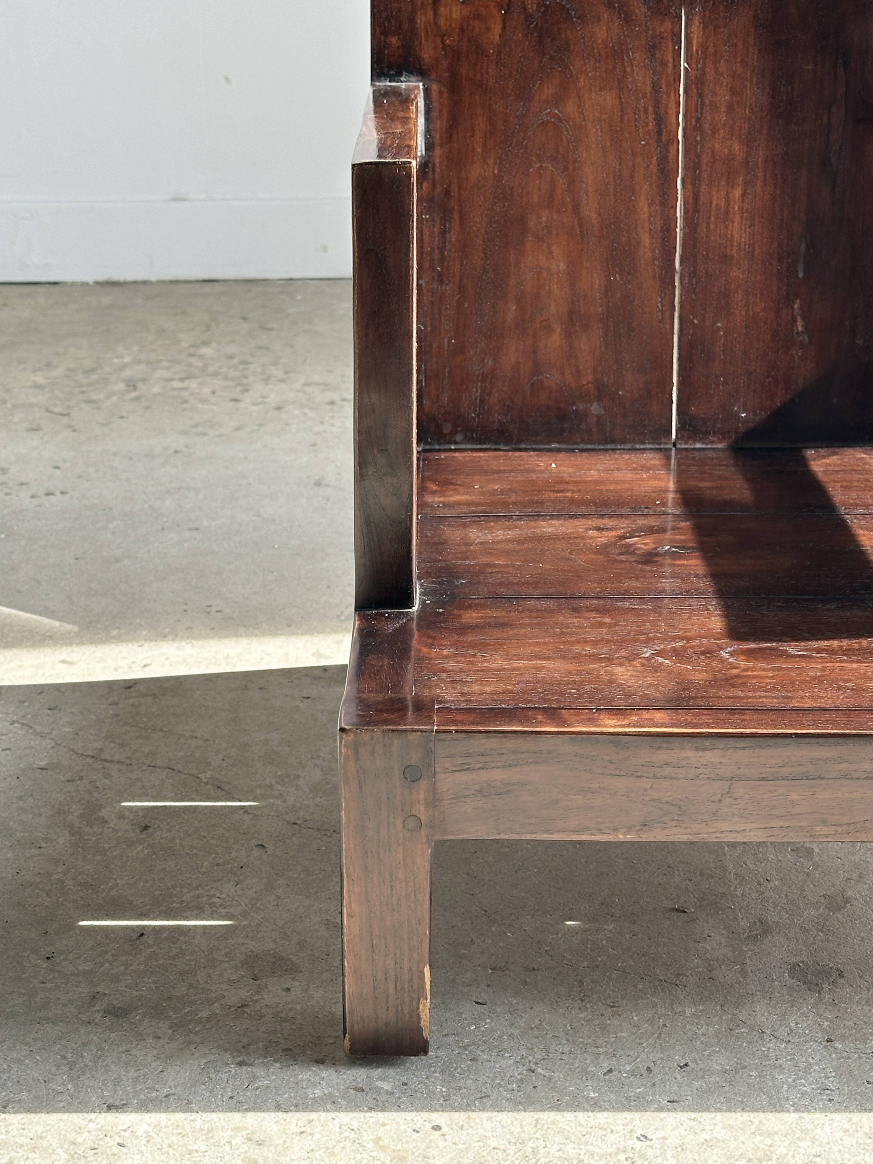 Small low armchair in varnished brown wood