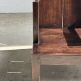 Small low armchair in varnished brown wood