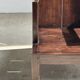 Small low armchair in varnished brown wood