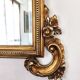 Large Italian mirror in carved wood, traditional gilding, 1980s.