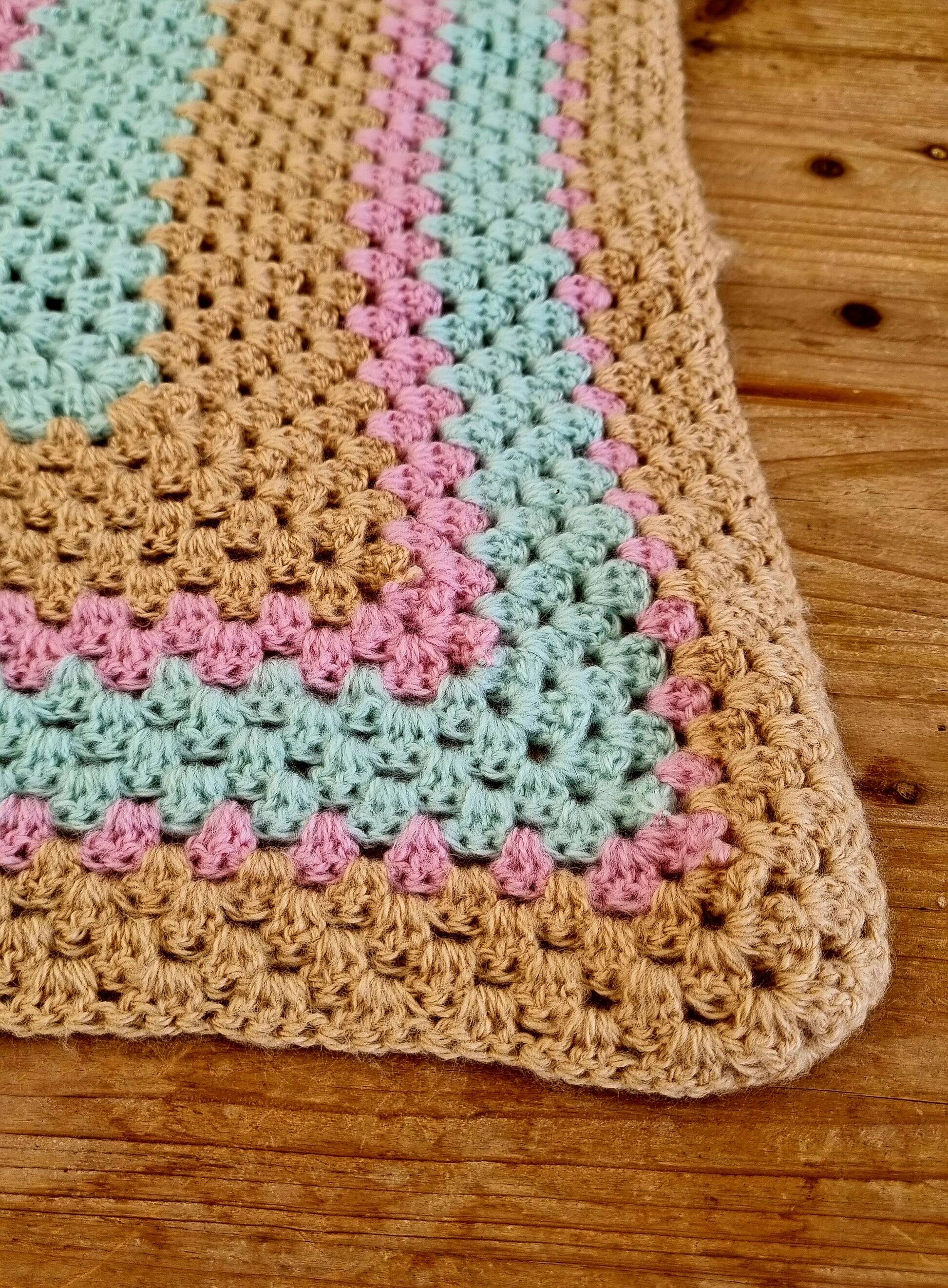 Vintage pastel crochet blanket for children.