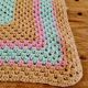 Vintage pastel crochet blanket for children.