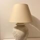 1980s ceramic table lamp with a wooden base and adjustable shade.