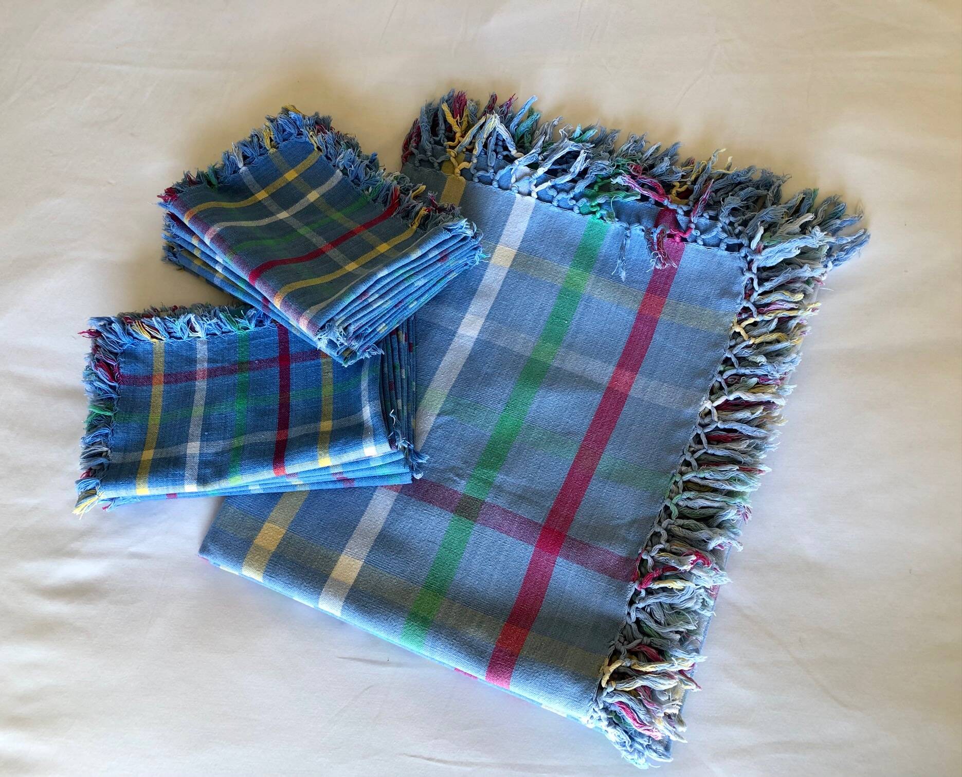 Vintage tablecloth & napkins, blue with multicoloured stripes.